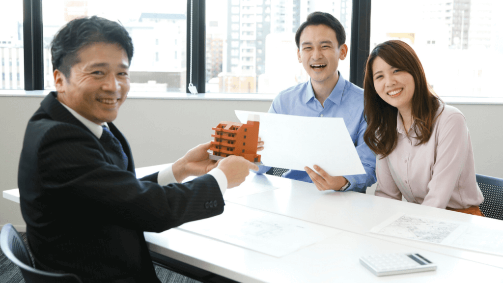 不動産投資アドバイザーと満足そうなお客の夫婦